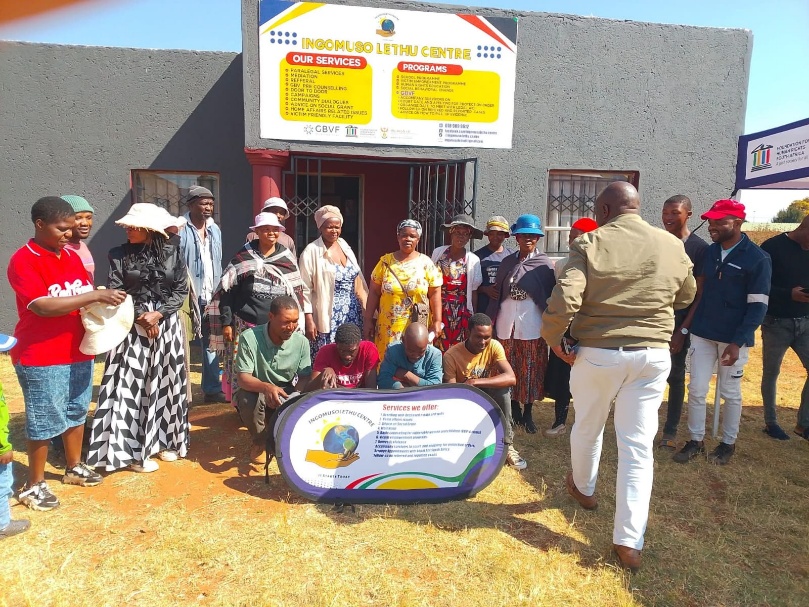 Community members gathered by the Ingomuso Lethu Centre sign