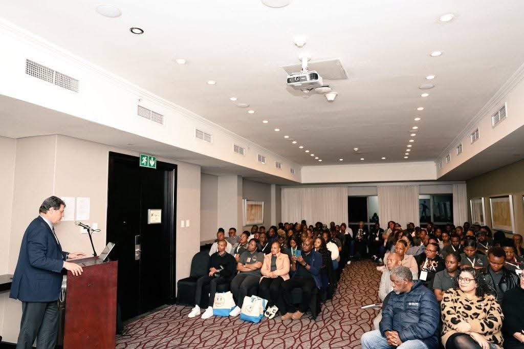 Large community workshop with participants seated in rows