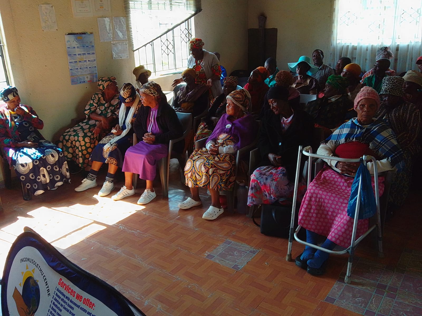 Older community members seated during a support and awareness session