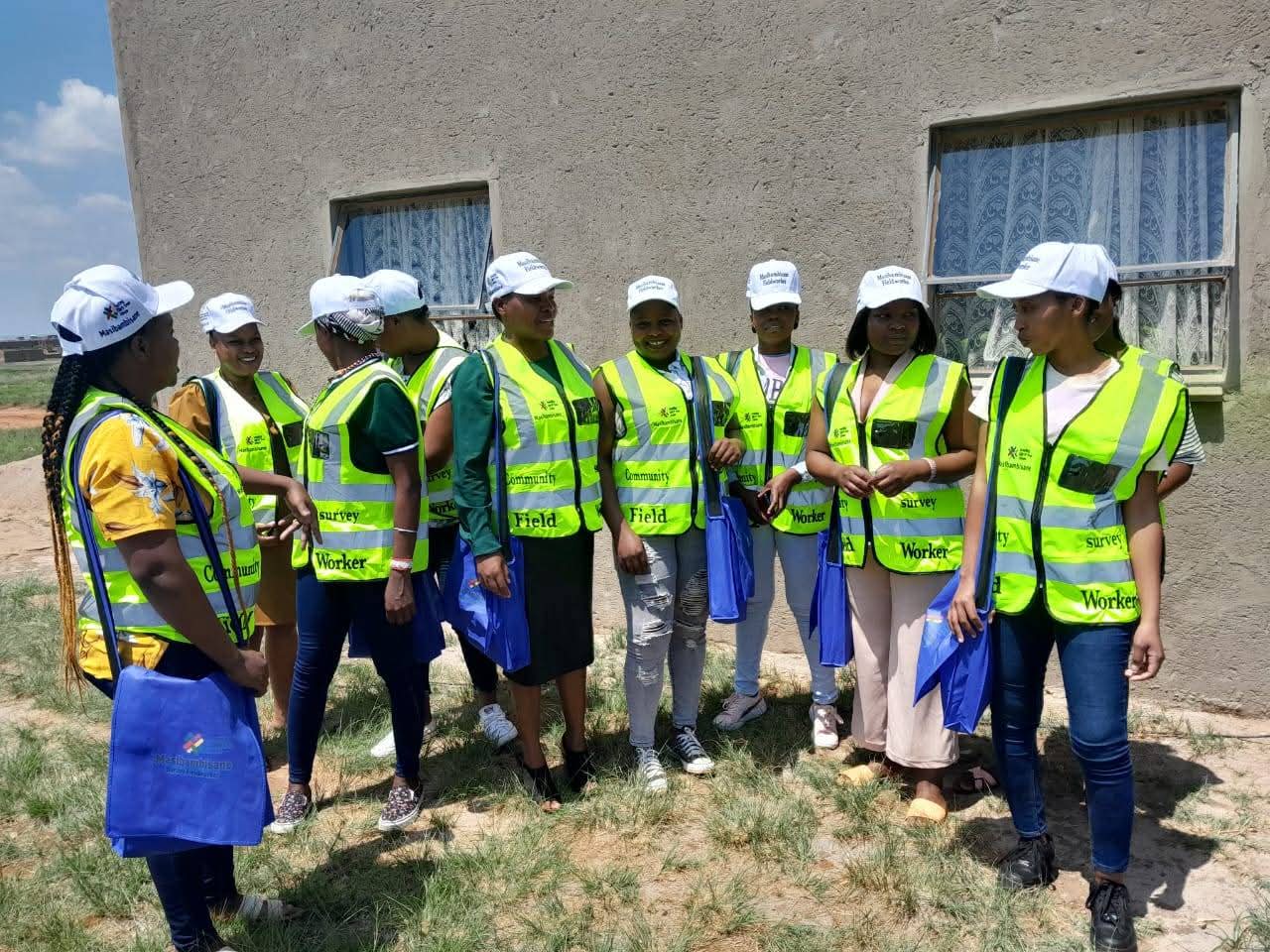 Field workers and partners standing together outside the centre