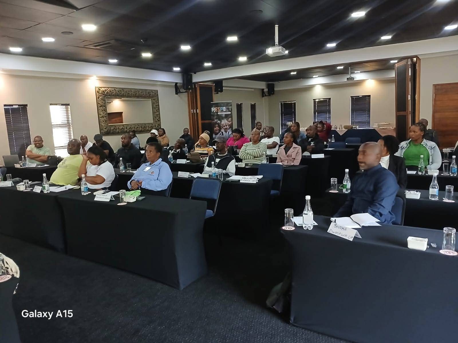 Participants seated at tables during a Respect community workshop