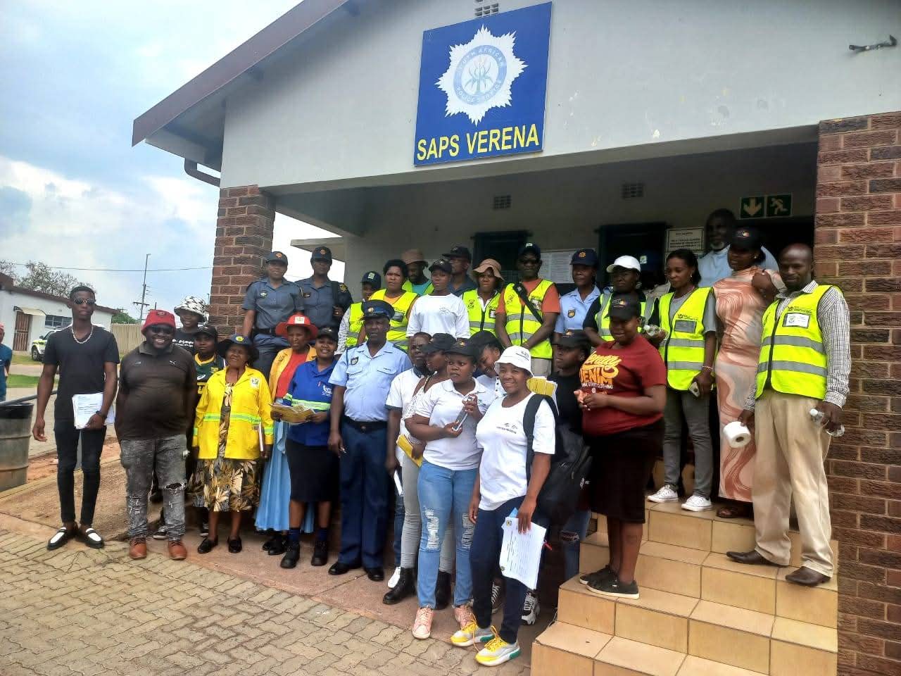 Community members and SAPS Verena officers gathered outside the police station