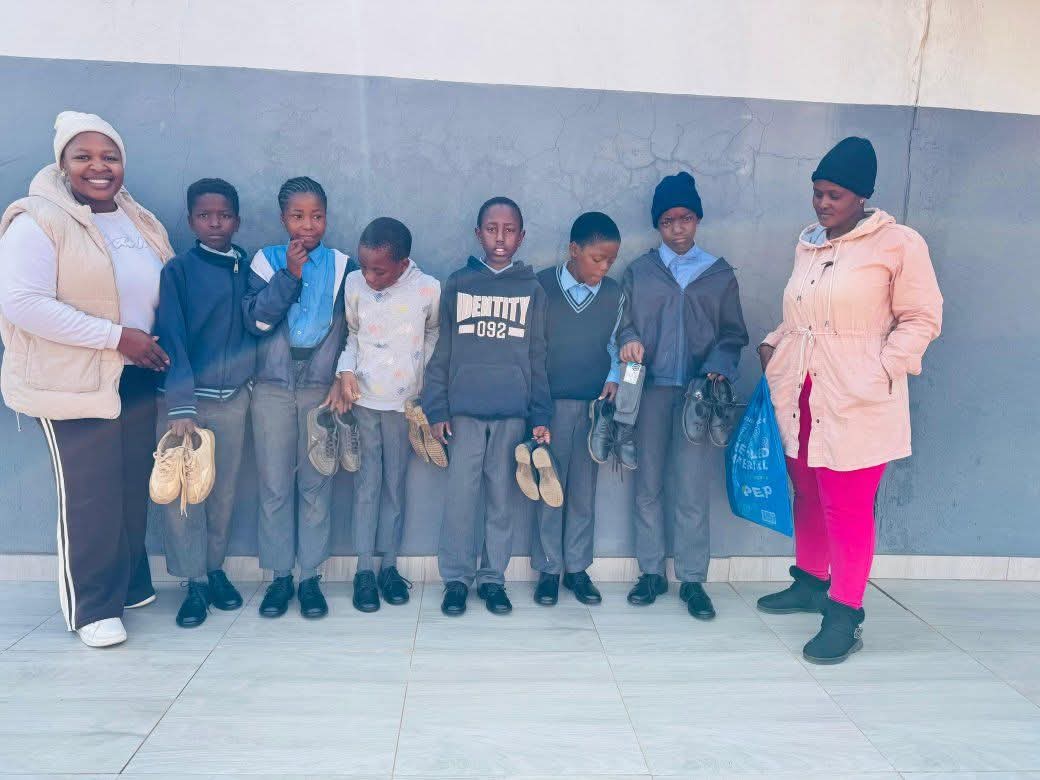 Students receiving school shoes during a school support activity